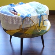 baby asleep in basket on coffee table